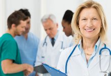 Doctor Standing In Front Of Her Co-worker