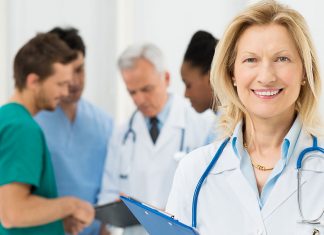 Doctor Standing In Front Of Her Co-worker