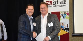 SDAHO Board Chair Curt Hohman congratulates Paul Hanson, executive vice president of Sanford USD Medical Center in Sioux Falls, on receiving an AHA PAC MVPP award.