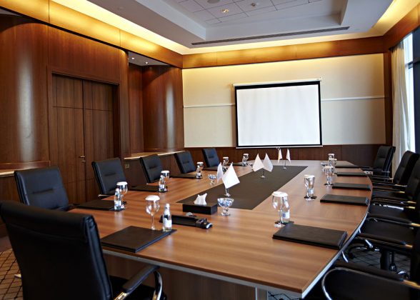 Conference room with a big polished table and arm-chairs