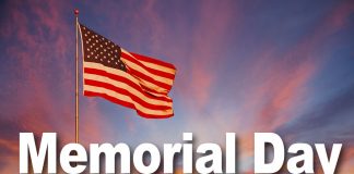 An orange and pink sunset surround the American Flag and makes it glow with pride.