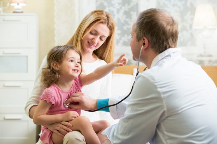 Doctor examining child