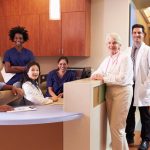 Portrait Of Medical Staff At Nurse’s Station In Hospital