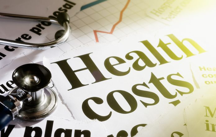 Sunlit headlines on health costs with stethoscope